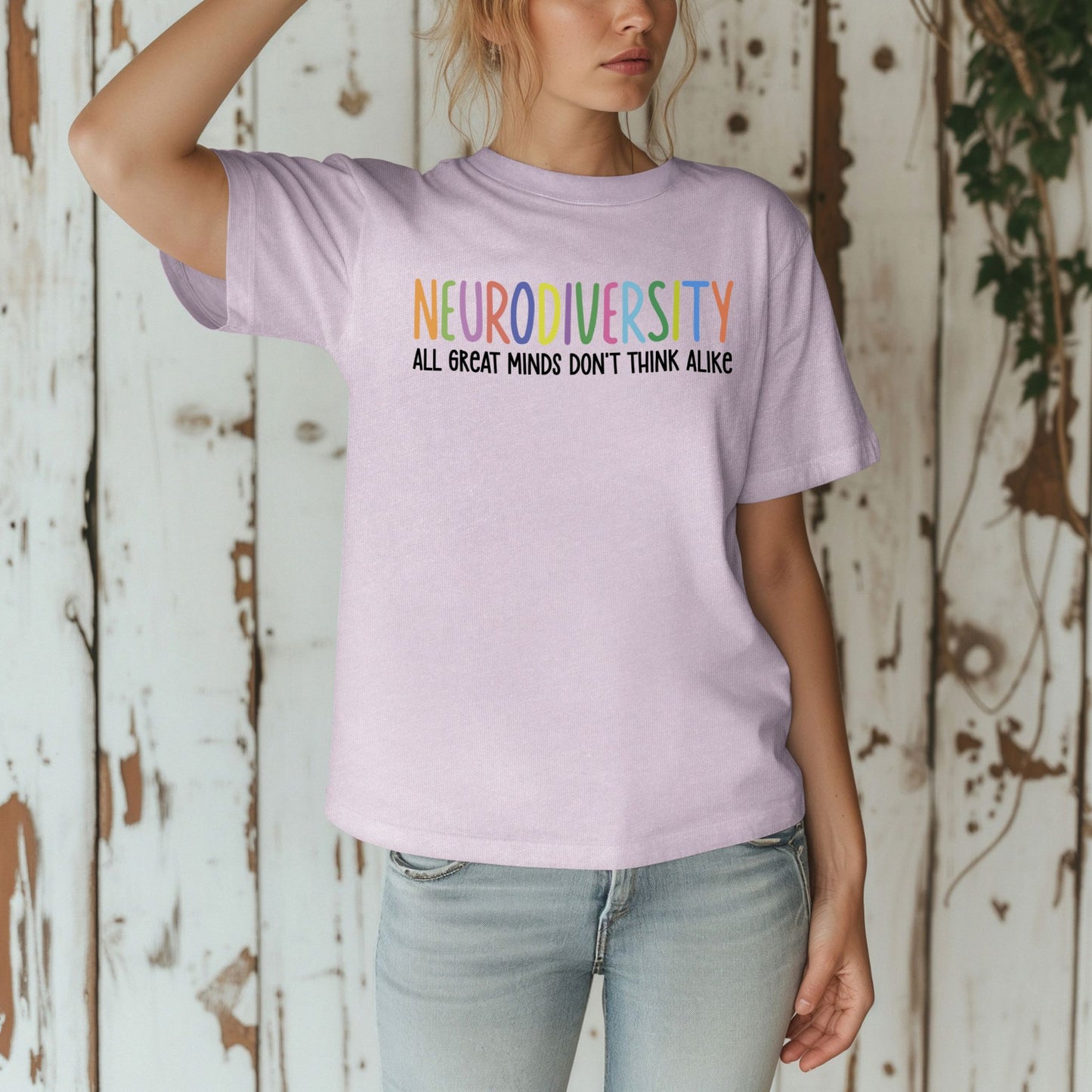 Person wearing a purple t-shirt with 'NEURODIVERSITY ALL GREAT MINDS DON'T THINK ALIKE' text.
