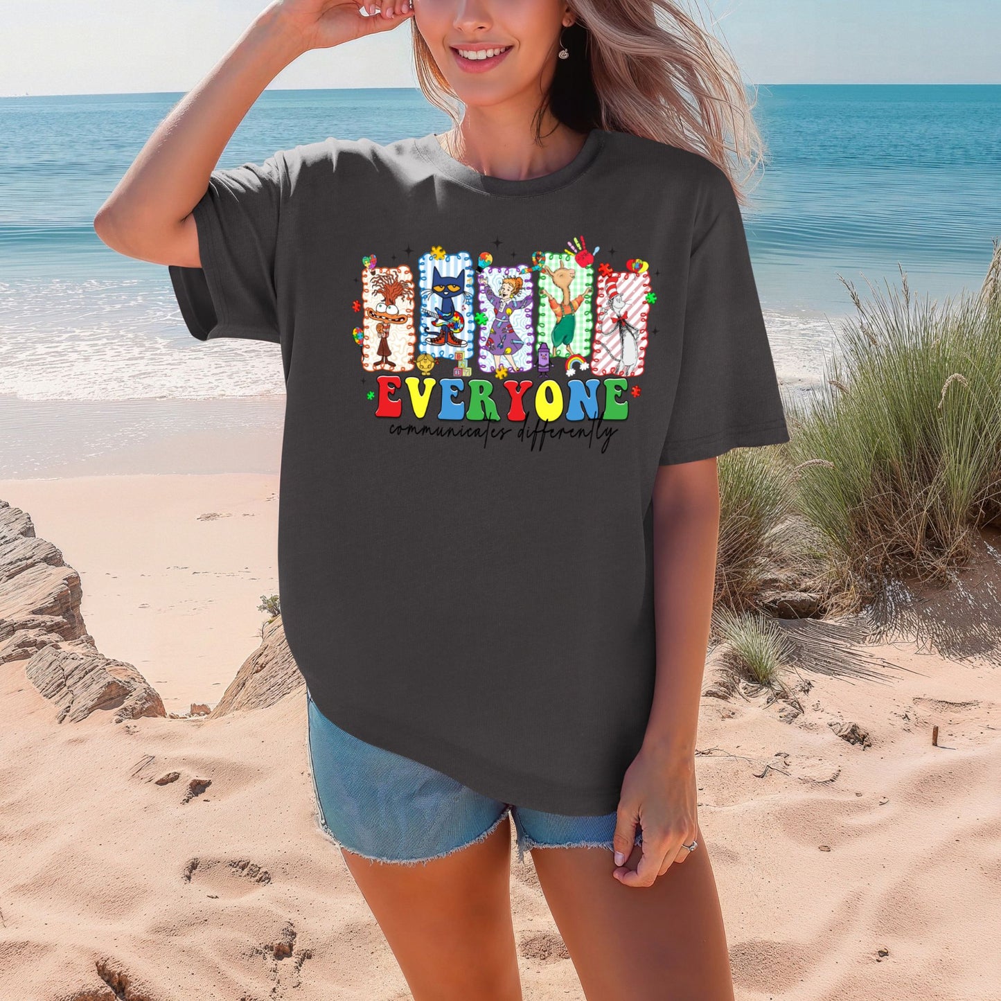 Woman wearing a black t-shirt with colorful text on a beach