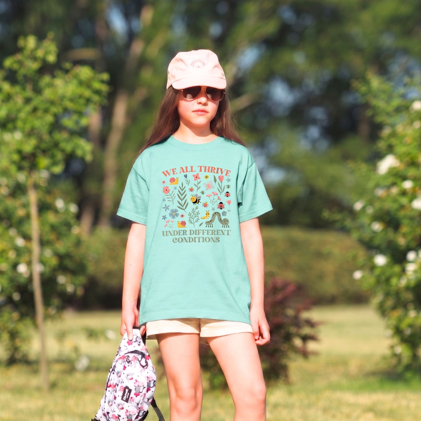 Person wearing a green t-shirt with a printed design outdoors